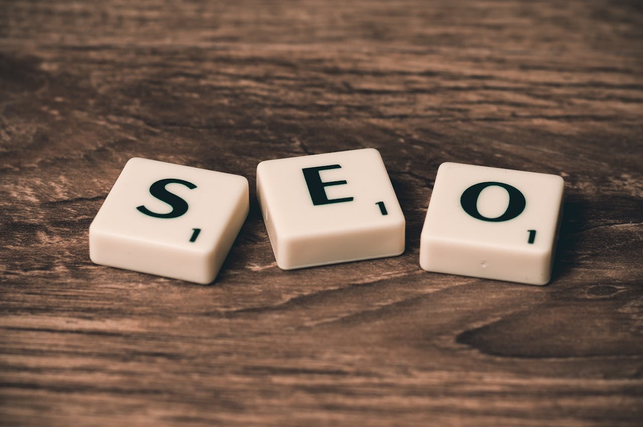 contact-header Scrabble tiles spelling SEO on a wooden surface. Ideal for digital marketing themes.